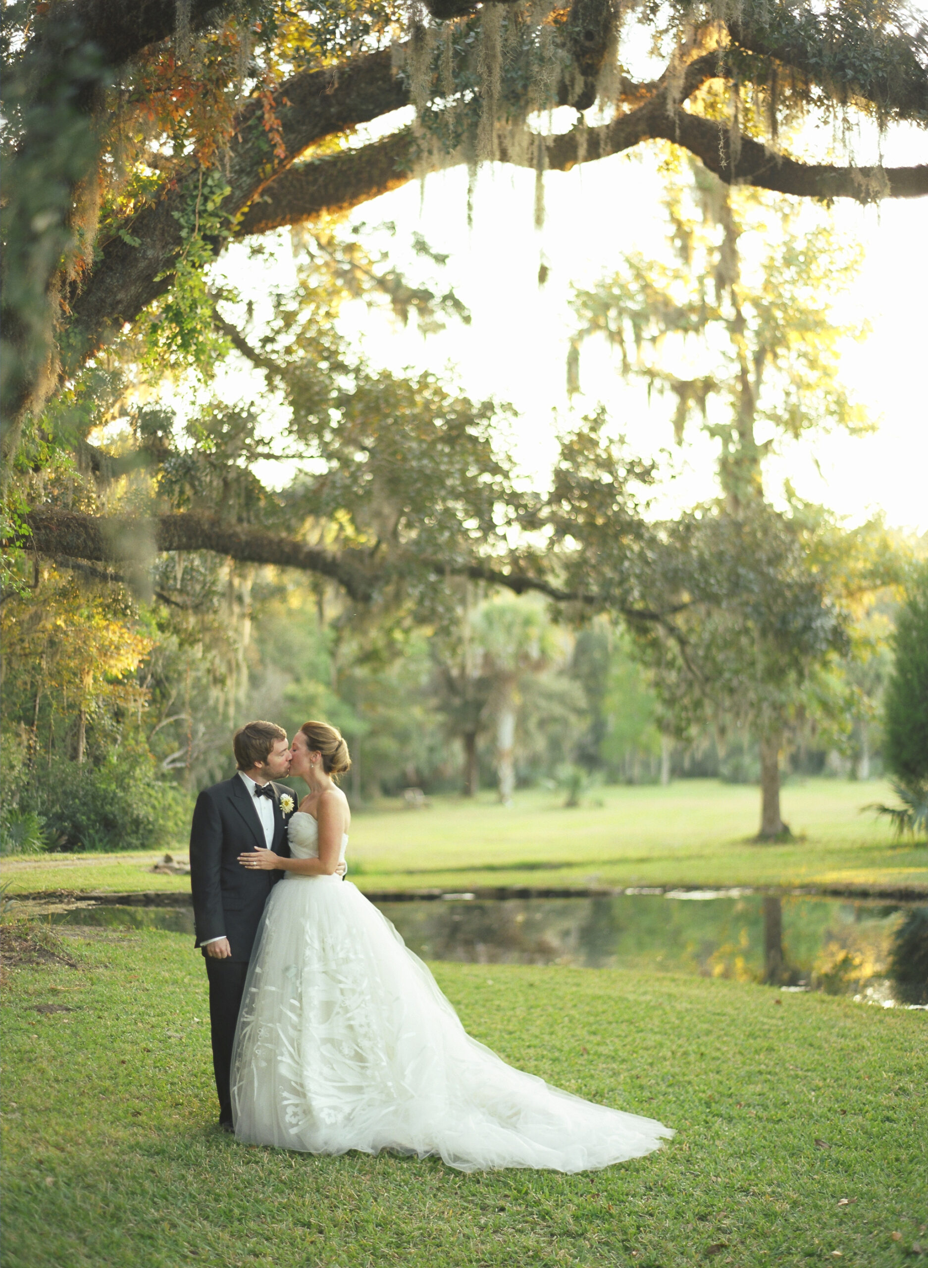 Carter Samis wears a stunning Carolina Hererra strapless ballgown of tulle for her wedding to Fred Fellers in Charleston South Carolina. The wedding was planned by Soirée by Tara Guérard. The reception took place at Historic Drayton Hall.