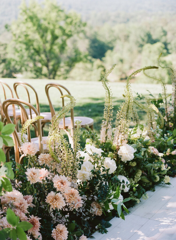 beautiful-flower-arrangement-on-wooden-chairs-for-wedding-ceremony