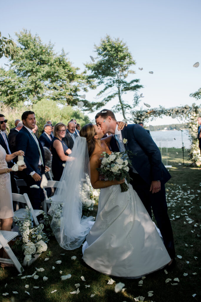bride-and-groom-kissing-in-the-aisle-after-ceremony