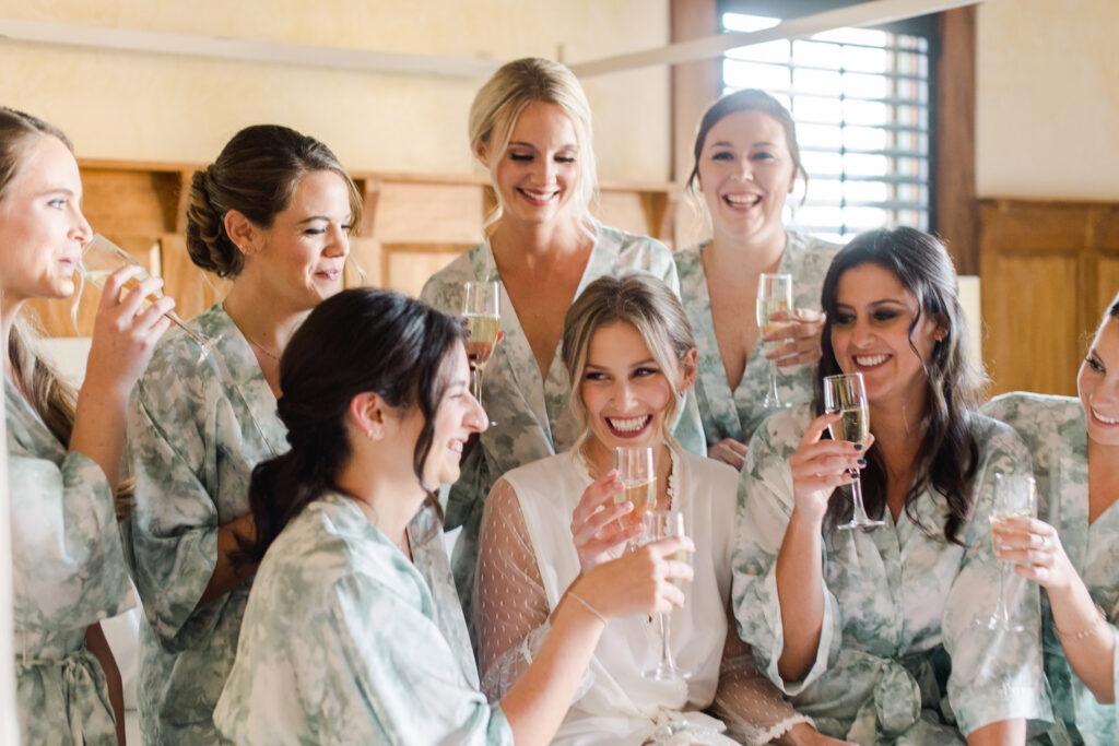 bride-and-bridesmaids-drinking-champaigne