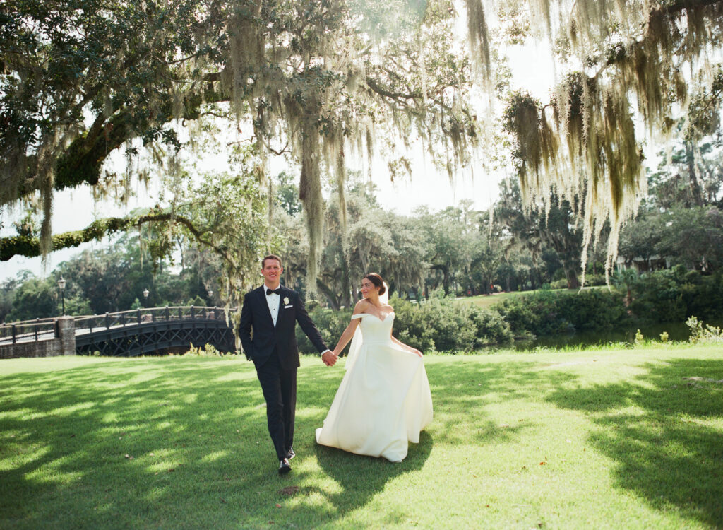 couple-walking-under-weeping-willow-on-wedding-day