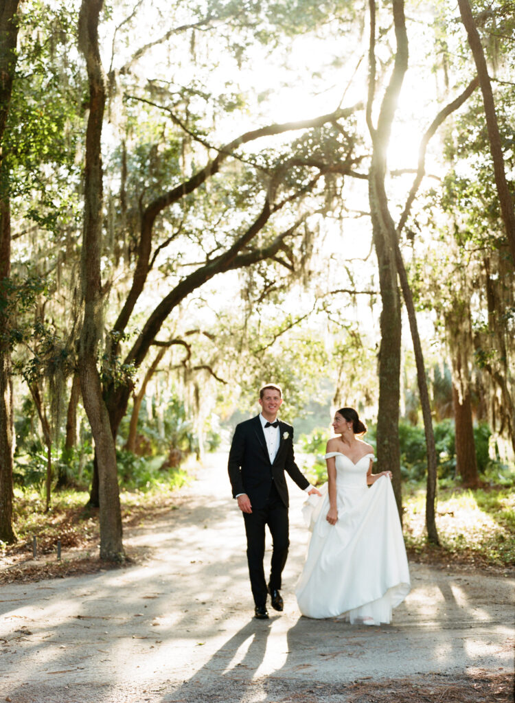 couple-backlit-walking-through-weeping-willow-treescape