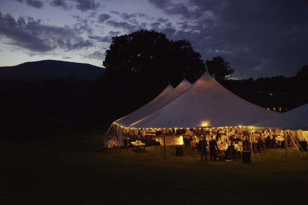 large-tented-wedding-at-night-with-warm-lighting-liz-banfield
