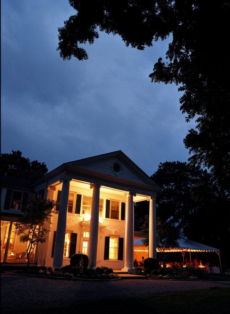 historic-home-wedding-venue-at-night-with-tented-wedding-tent